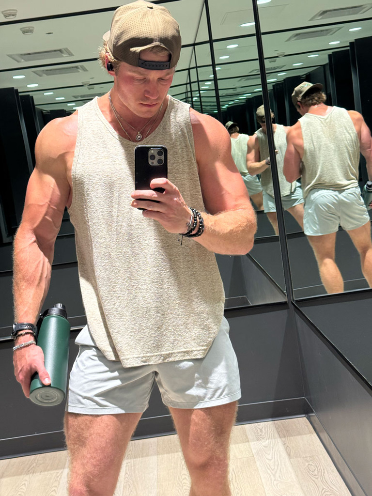 The coach is posing while looking at the mirror.